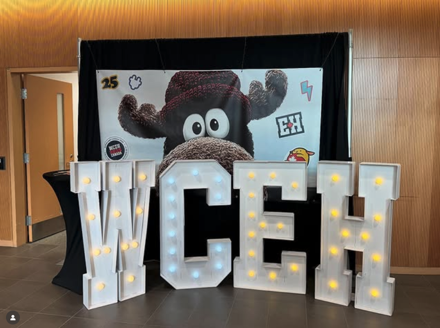 Large light up letters that read "WCEH" with a big moose behind them.